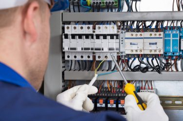 Male Technician Checking Fusebox